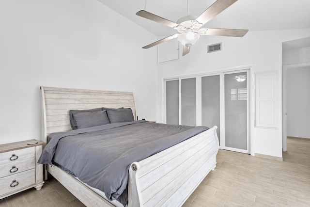 bedroom with ceiling fan, high vaulted ceiling, and hardwood / wood-style flooring