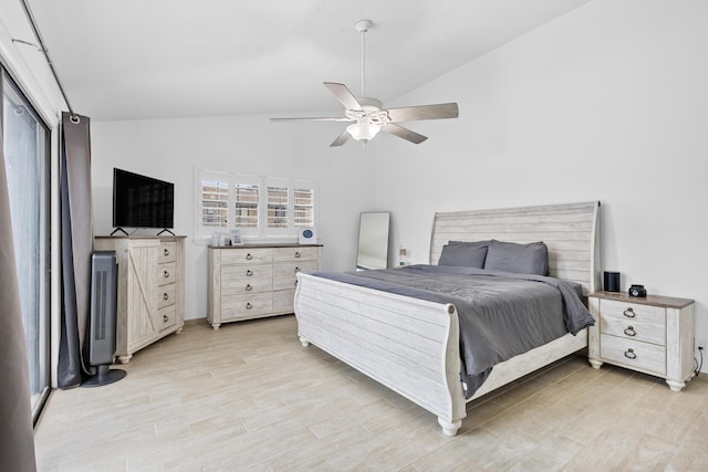 bedroom featuring ceiling fan, light wood-type flooring, and vaulted ceiling