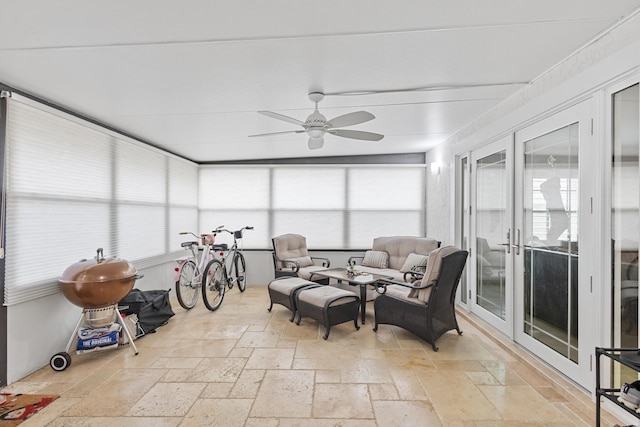 sunroom / solarium featuring ceiling fan, plenty of natural light, and french doors