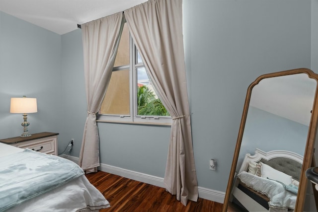 bedroom with dark wood-type flooring