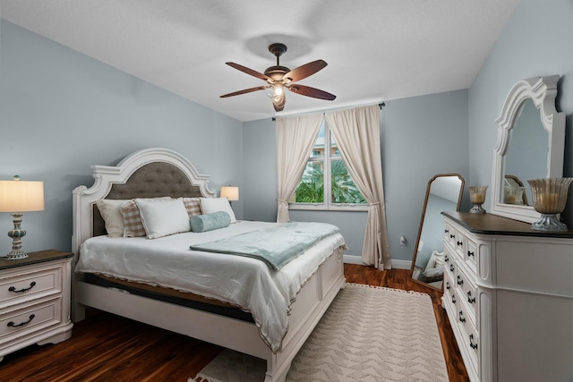 bedroom with dark hardwood / wood-style flooring and ceiling fan