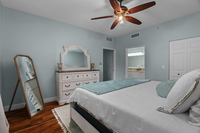 bedroom featuring dark hardwood / wood-style flooring, ensuite bath, and ceiling fan