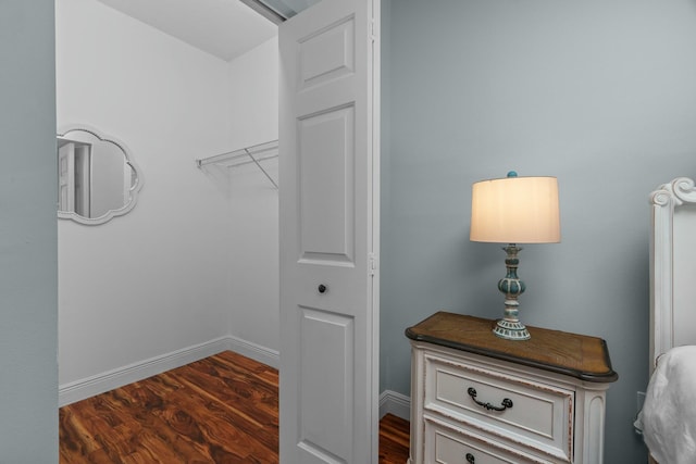 spacious closet with dark wood-type flooring