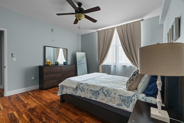 bedroom featuring a textured ceiling, ceiling fan, and dark wood-type flooring