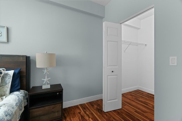 interior space with dark hardwood / wood-style floors and a closet