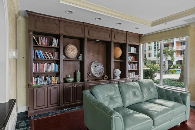 living area with dark hardwood / wood-style flooring and crown molding