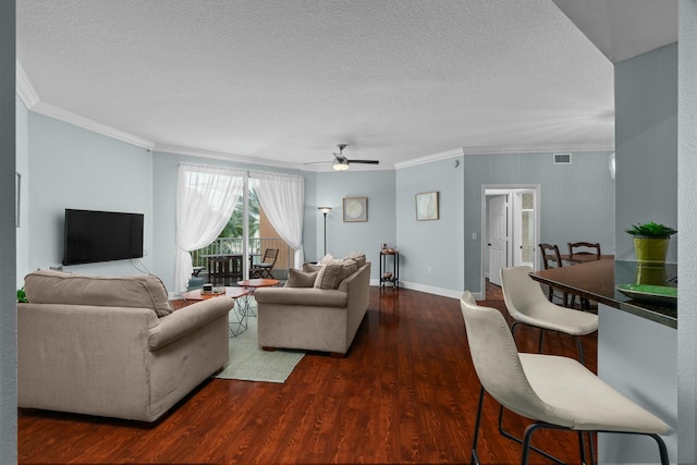 living room featuring dark hardwood / wood-style floors, ceiling fan, crown molding, and a textured ceiling