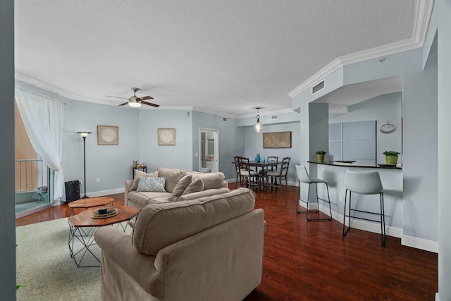 living room with crown molding, ceiling fan, dark hardwood / wood-style flooring, and a textured ceiling