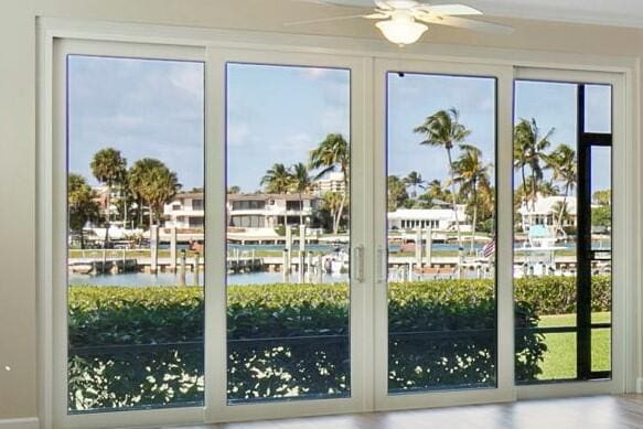 entryway with ceiling fan and a water view