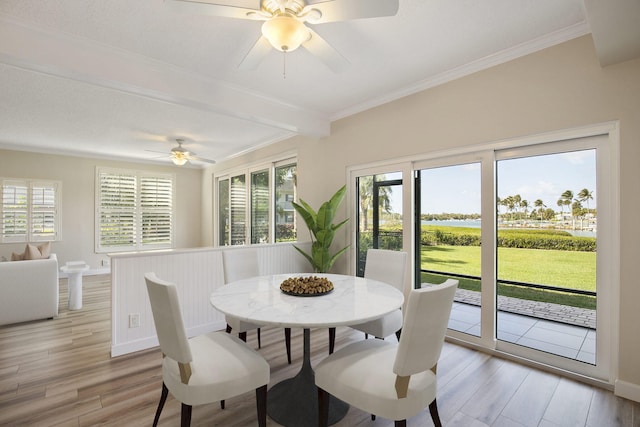 dining space featuring light hardwood / wood-style floors, ceiling fan, and ornamental molding