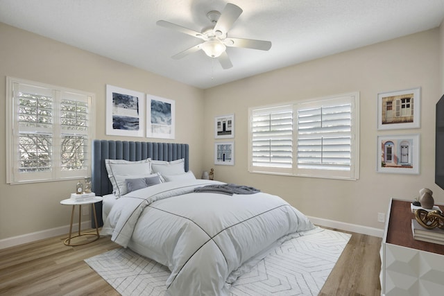 bedroom featuring a textured ceiling, light hardwood / wood-style flooring, and ceiling fan