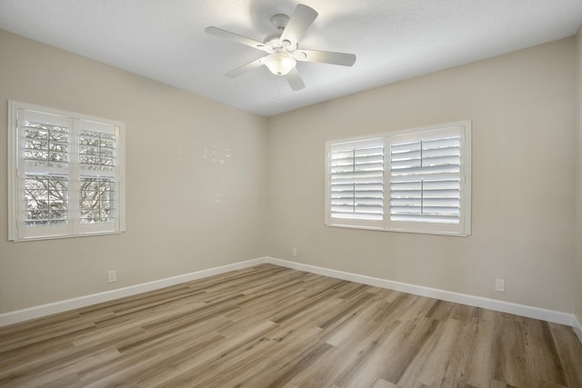 spare room with ceiling fan, light hardwood / wood-style flooring, and a textured ceiling