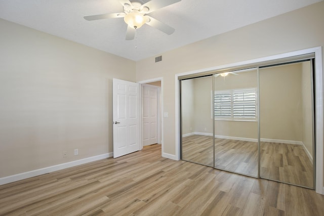 unfurnished bedroom with ceiling fan, a closet, and light hardwood / wood-style floors