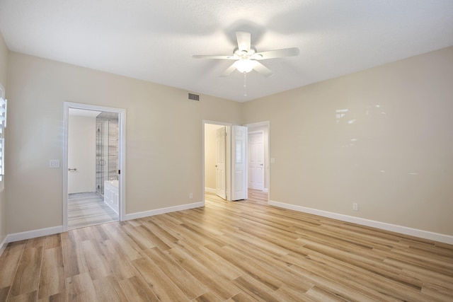 spare room featuring a textured ceiling, light hardwood / wood-style floors, and ceiling fan