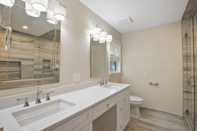 bathroom featuring hardwood / wood-style floors, vanity, toilet, and walk in shower