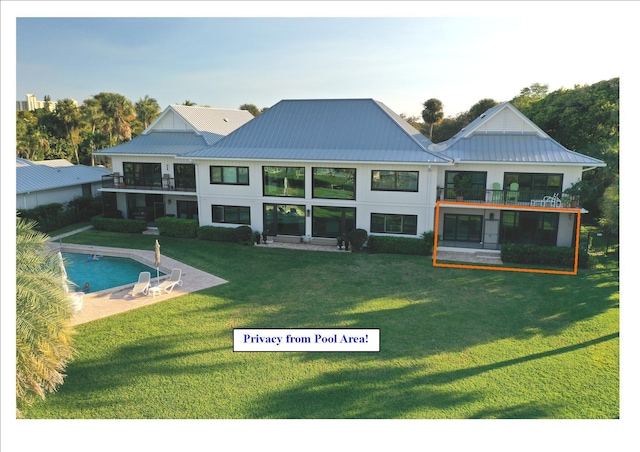 rear view of property with a lawn and a balcony