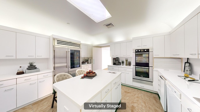 kitchen with a center island, white cabinetry, and stainless steel appliances