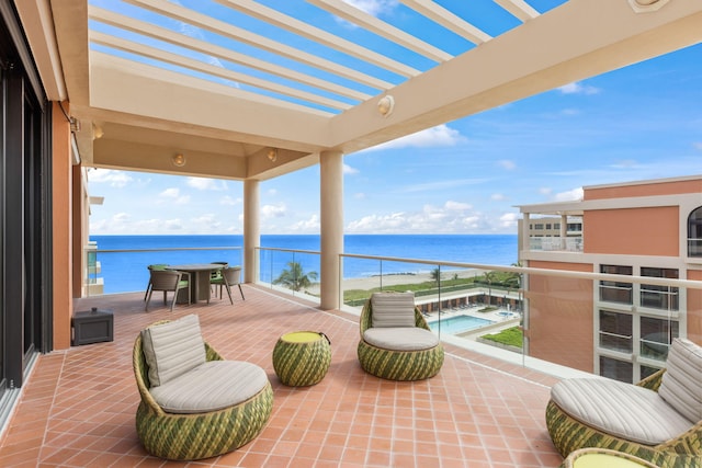 view of patio featuring a pergola, a water view, and a balcony