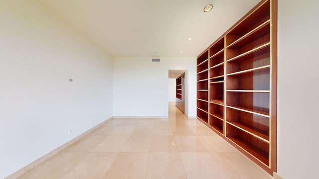 corridor featuring light tile patterned floors