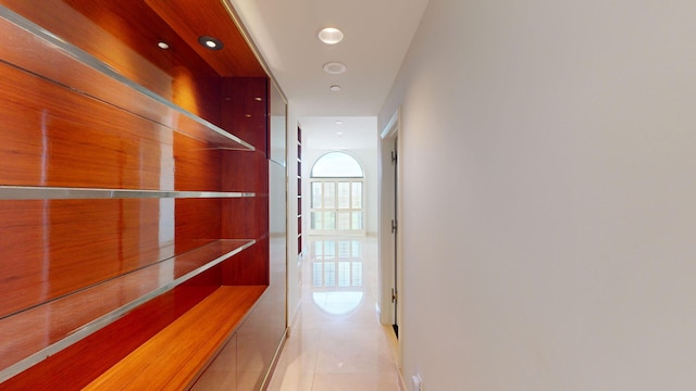 hall with light tile patterned floors