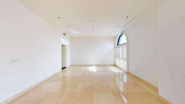 unfurnished room featuring light tile patterned floors