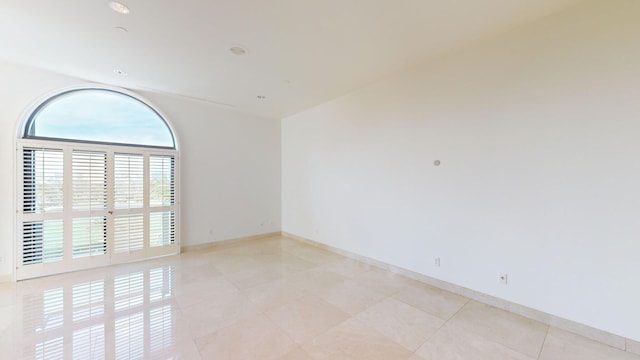 spare room with light tile patterned floors