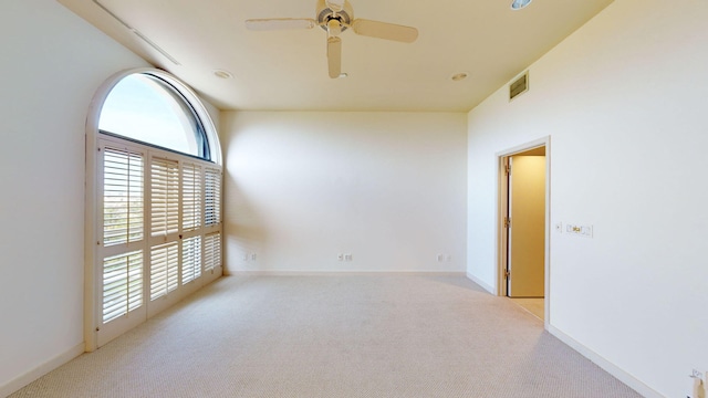 empty room featuring light colored carpet and ceiling fan