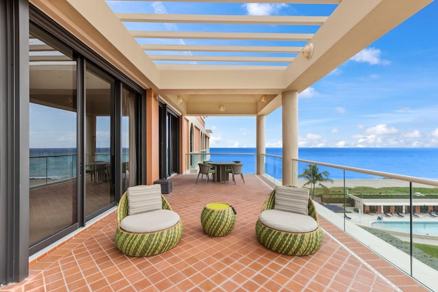 balcony with a pergola and a water view