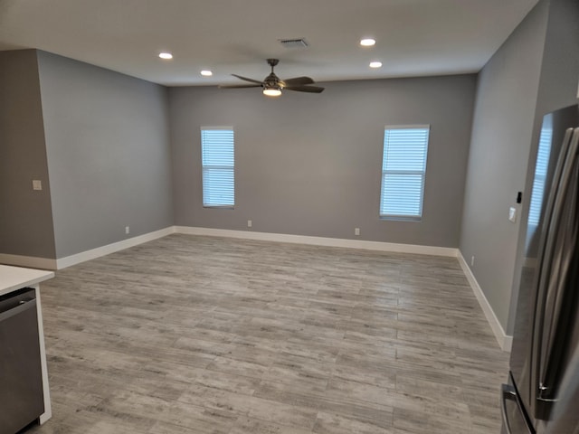 unfurnished living room with ceiling fan, plenty of natural light, and light wood-type flooring