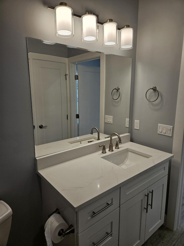 bathroom with hardwood / wood-style flooring, vanity, and toilet