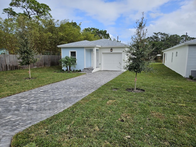 ranch-style home featuring a garage and a front lawn