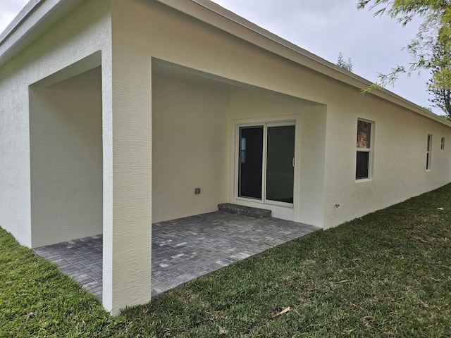 rear view of house with a lawn and a patio area