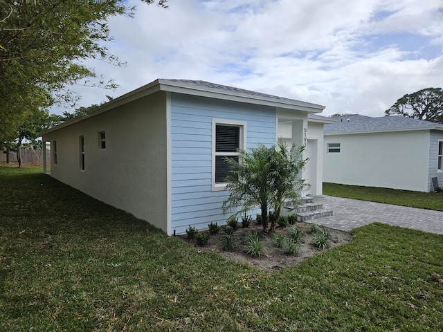 view of side of home featuring a lawn