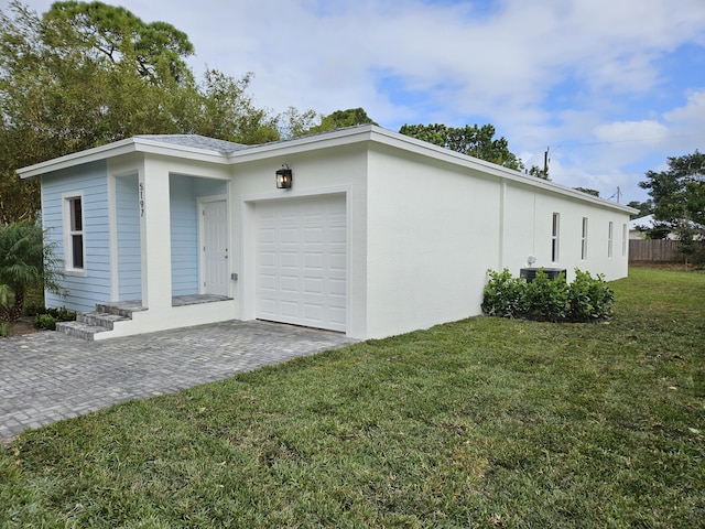 view of side of property with a yard and a garage