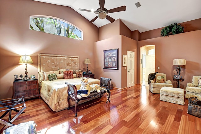 bedroom with ceiling fan, wood-type flooring, and lofted ceiling