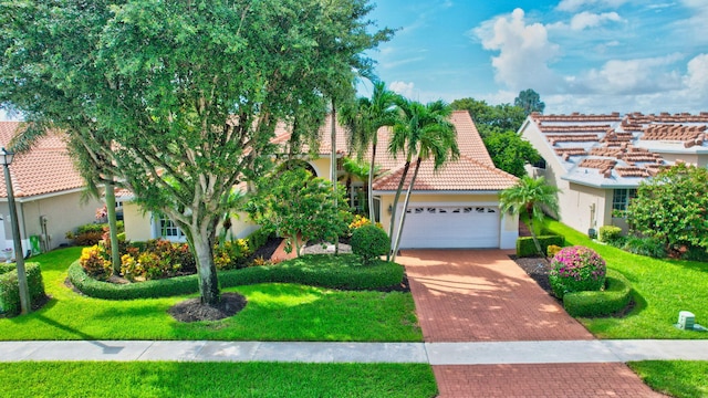 view of front facade with a garage and a front yard