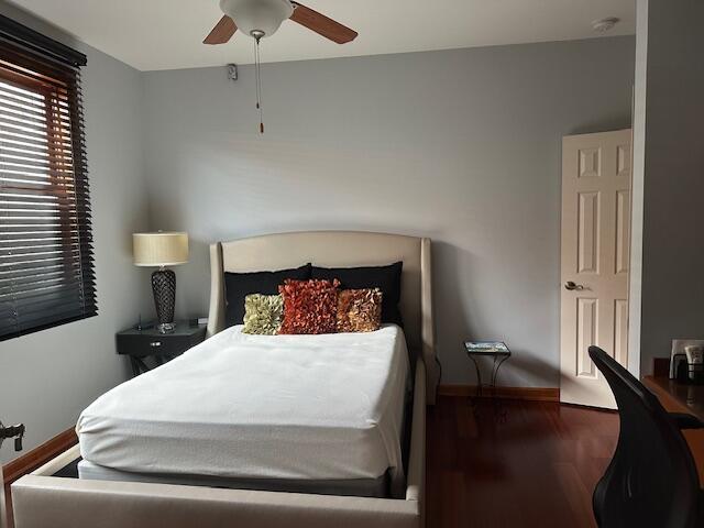 bedroom with ceiling fan and wood-type flooring