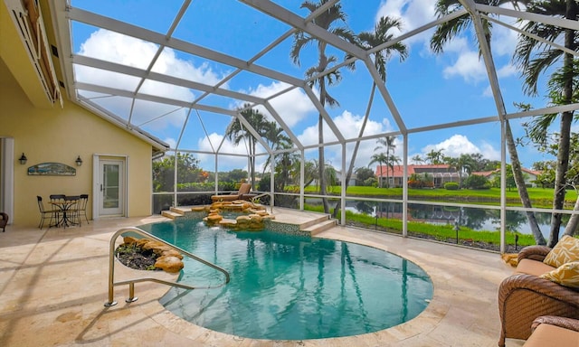 view of swimming pool featuring glass enclosure, a patio area, a water view, and pool water feature