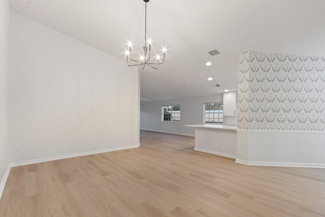 interior space featuring light hardwood / wood-style floors and a notable chandelier