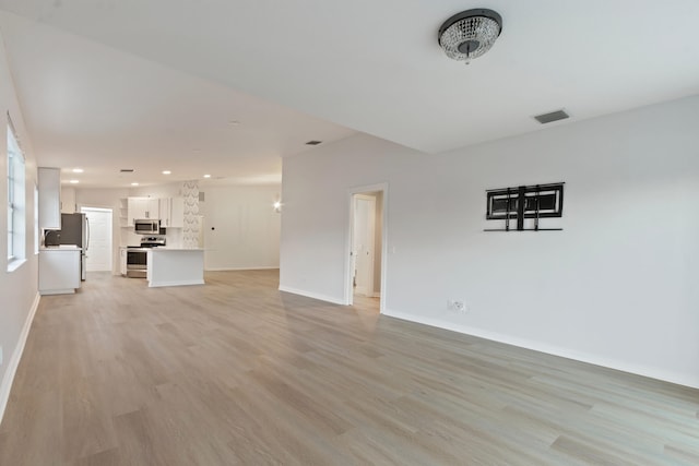 unfurnished living room with light wood-type flooring