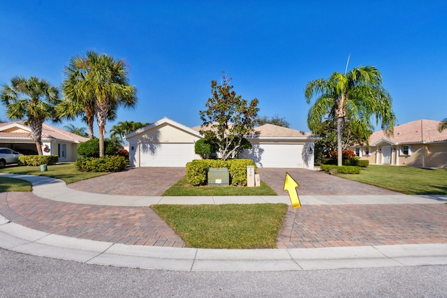 view of front of home featuring a garage and a front yard