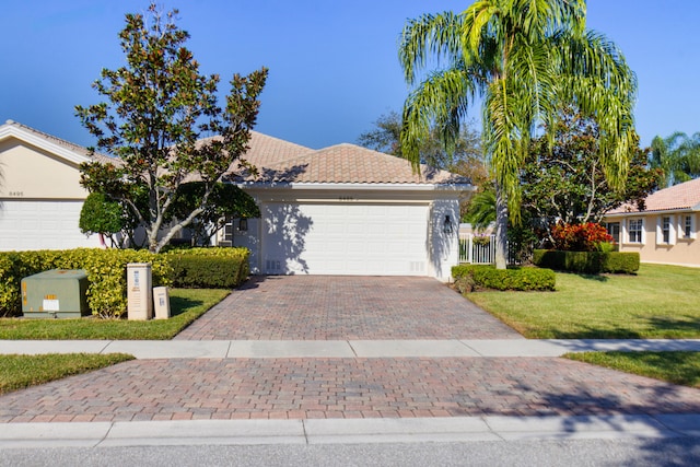 view of front of house with a front yard and a garage