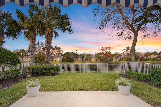 yard at dusk with a patio area