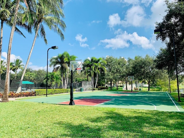 view of basketball court with a lawn