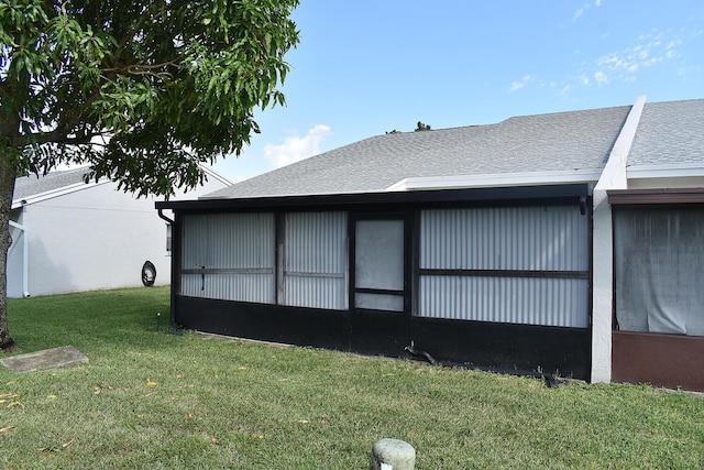 view of side of property with a lawn