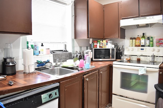 kitchen featuring backsplash, white appliances, dark brown cabinetry, sink, and butcher block counters