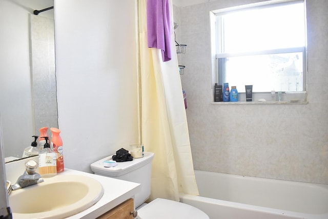 full bathroom featuring shower / bath combination with curtain, vanity, and toilet