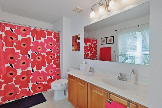 bathroom with tile patterned floors, vanity, and toilet