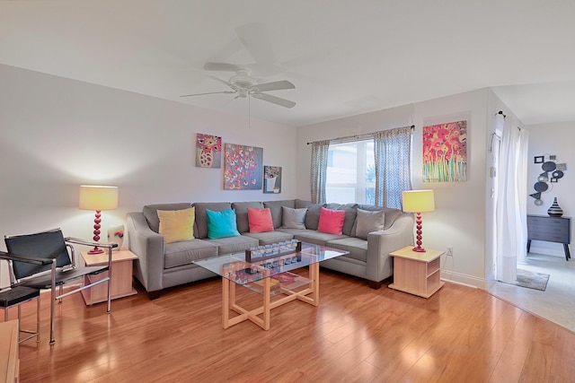 living room featuring hardwood / wood-style flooring and ceiling fan