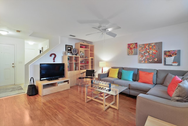 living room featuring ceiling fan and hardwood / wood-style floors